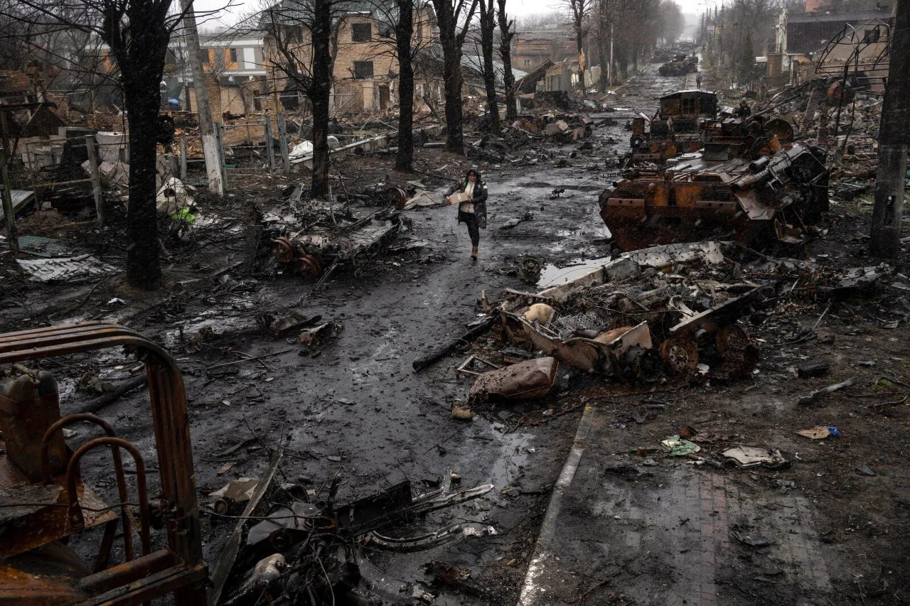 Destroyed military vehicles and rubble-strewn street in Ukraine following Russian strikes, featured in Semper Incolumem's strategic intelligence analysis of the Russia-Ukraine conflict