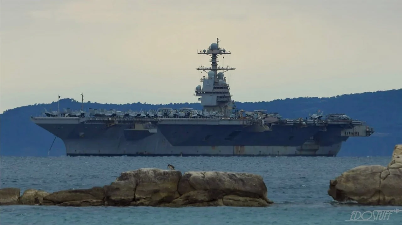 USS Gerald R. Ford aircraft carrier (CVN-78) at Naval Support Activity Souda Bay, Greece for repairs following a laundry room fire during Operation Epic Fury, as analyzed in Semper Incolumem's strategic intelligence report on US military readiness