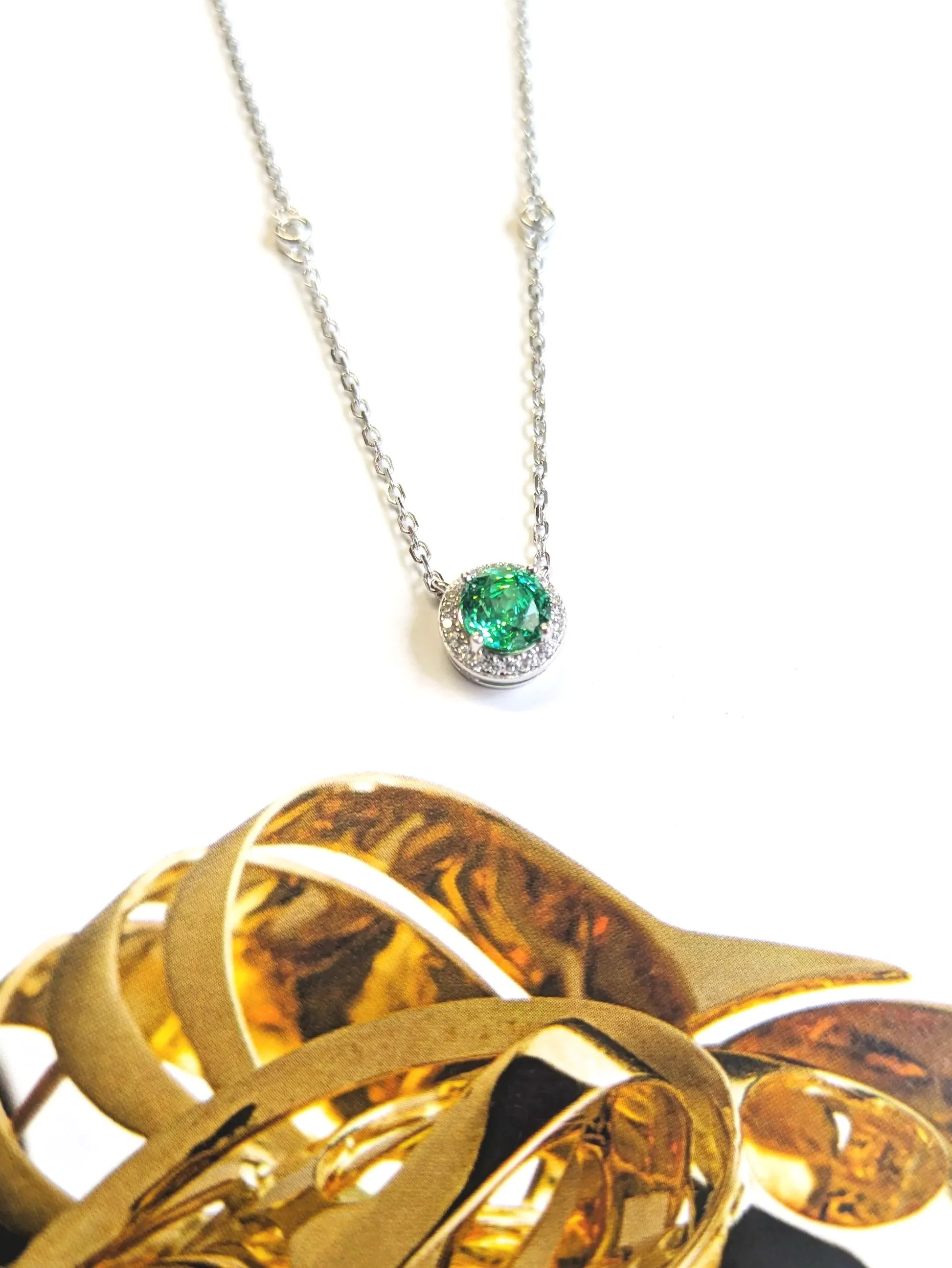 Silver necklace with round green emerald colour