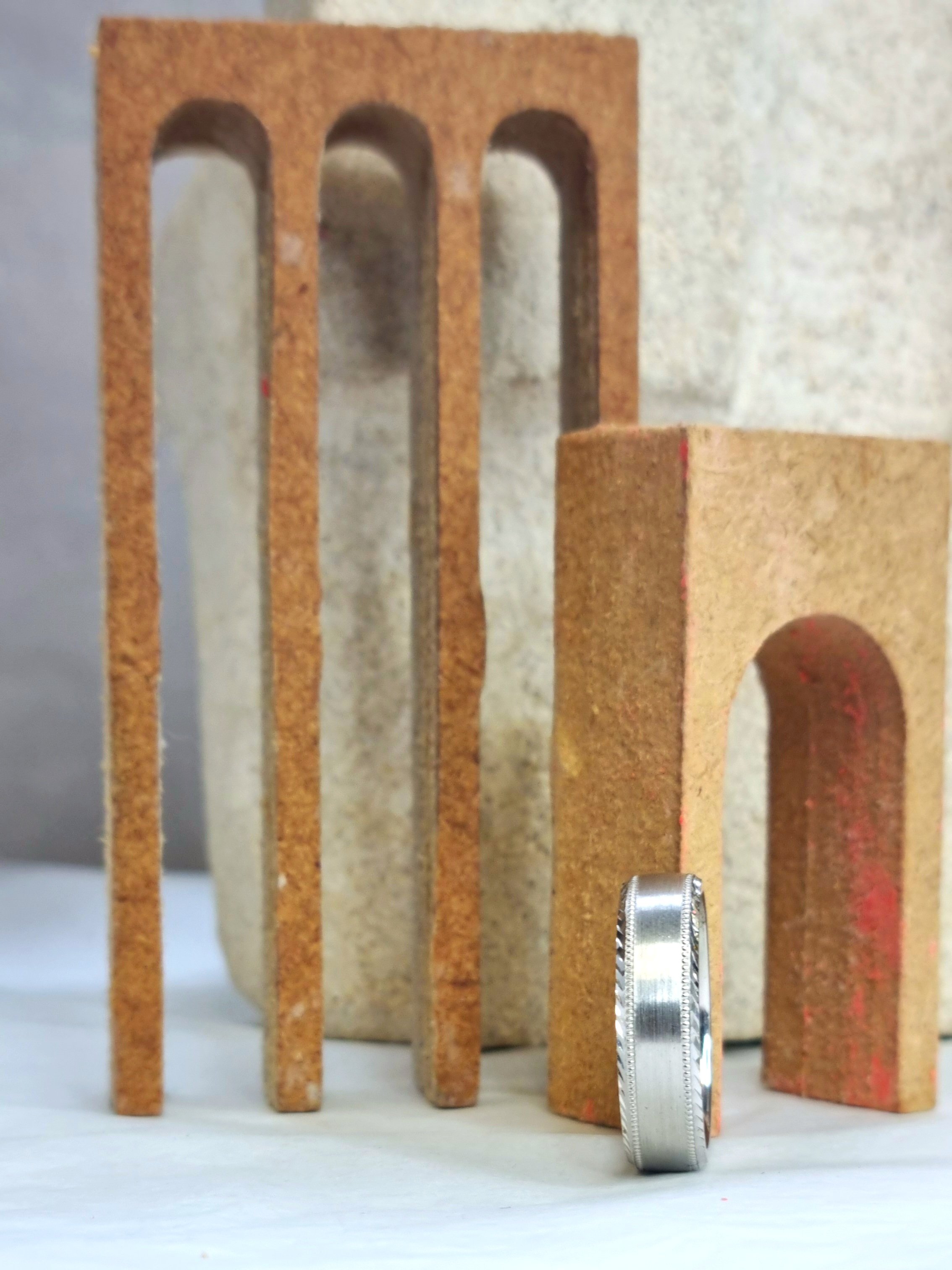 Wedding band on wooden arches with light background