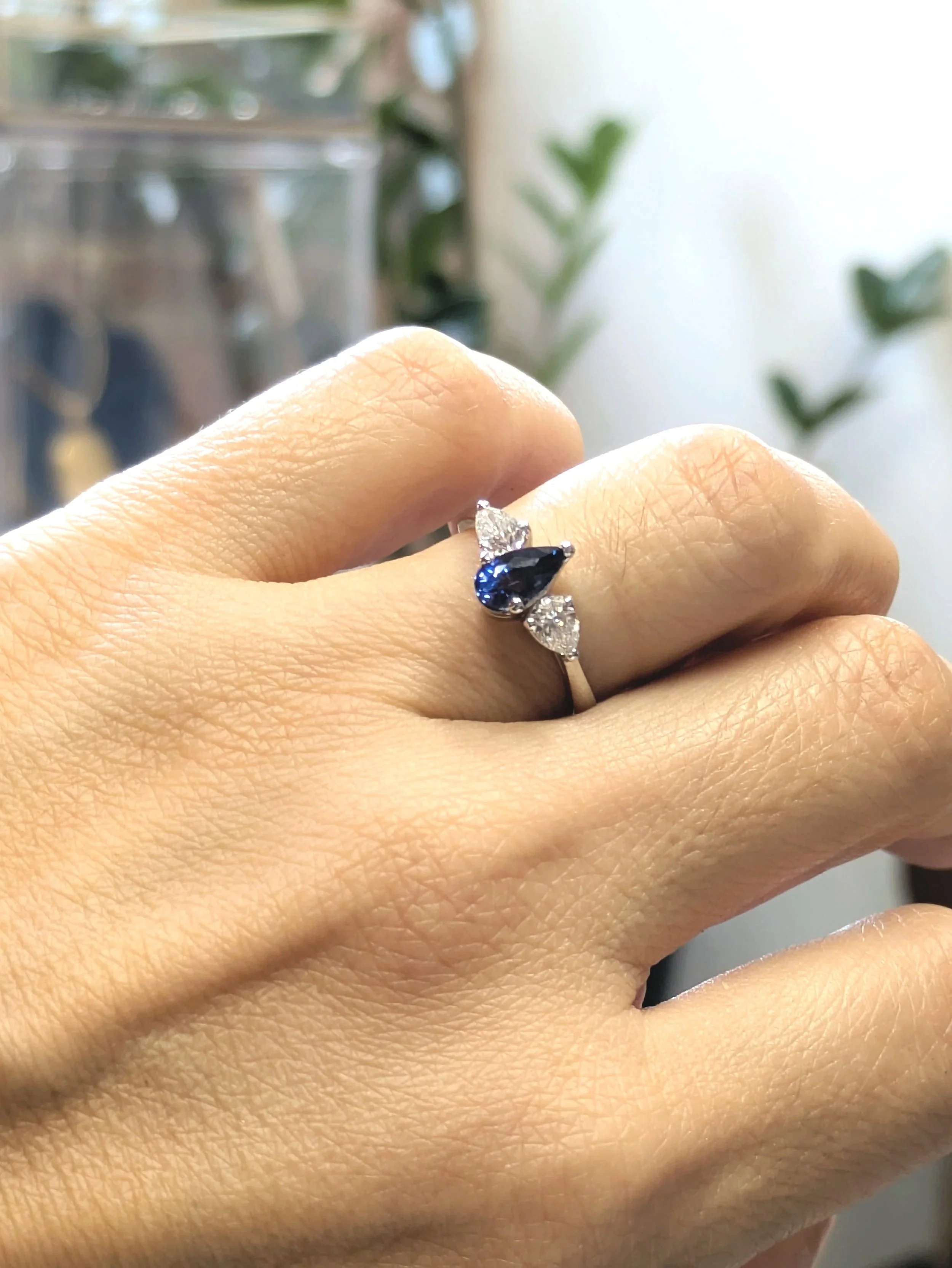 Model wearing an engagement sapphire & diamond ring