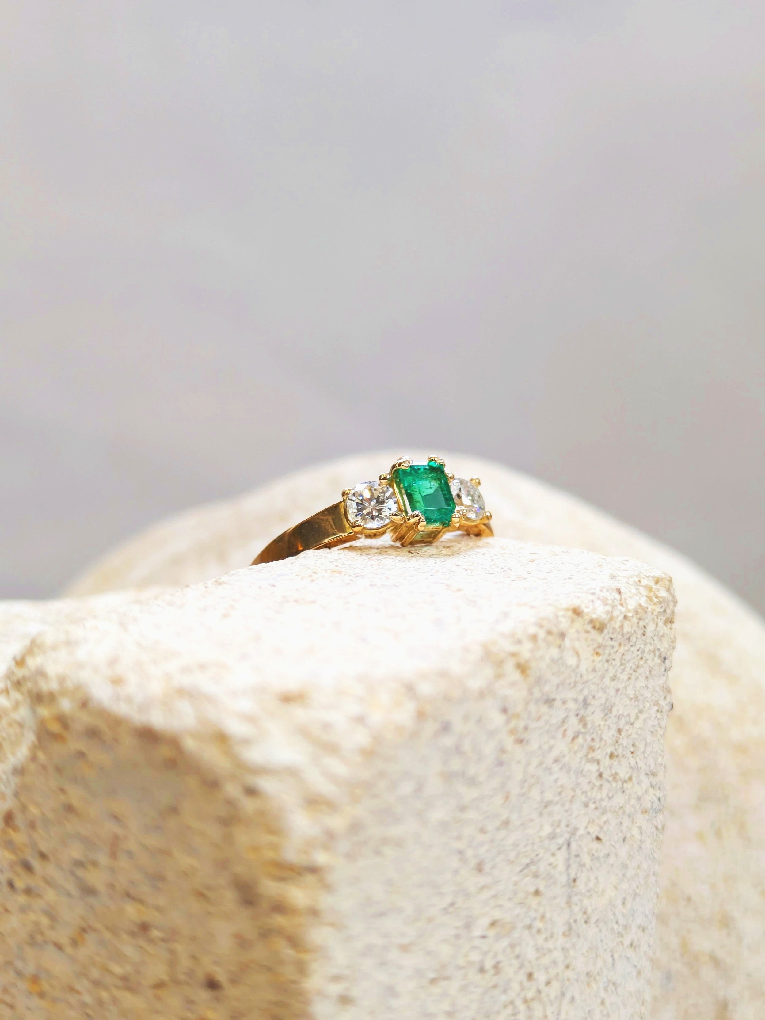 Trilogy Emerald Ring display in a solid sculpture