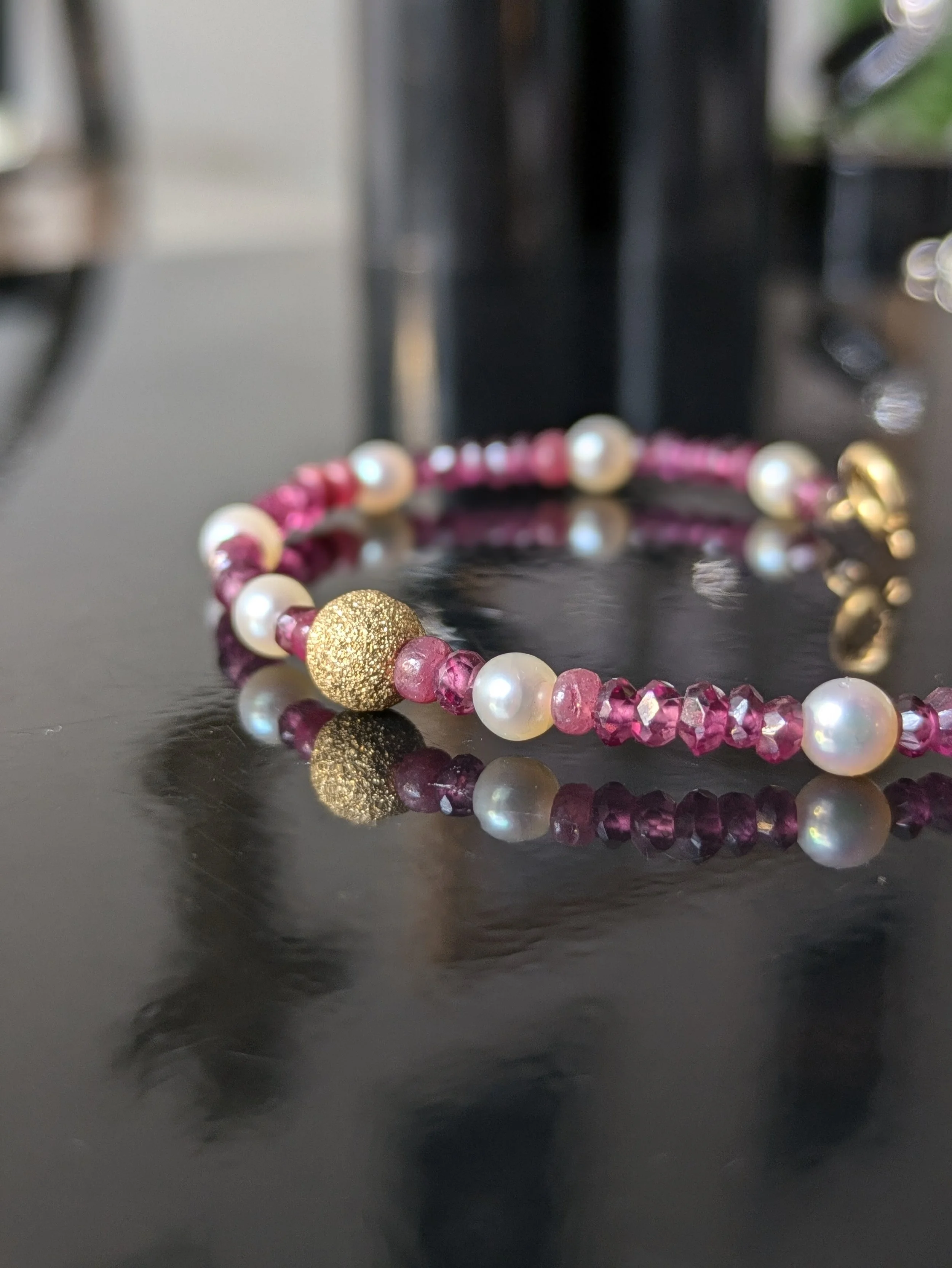 Handcrafted Bracelet with sweet pearls, faceted rubies and laser cu gold bracelet, our designs are manufacture in our workshop in London Brixton