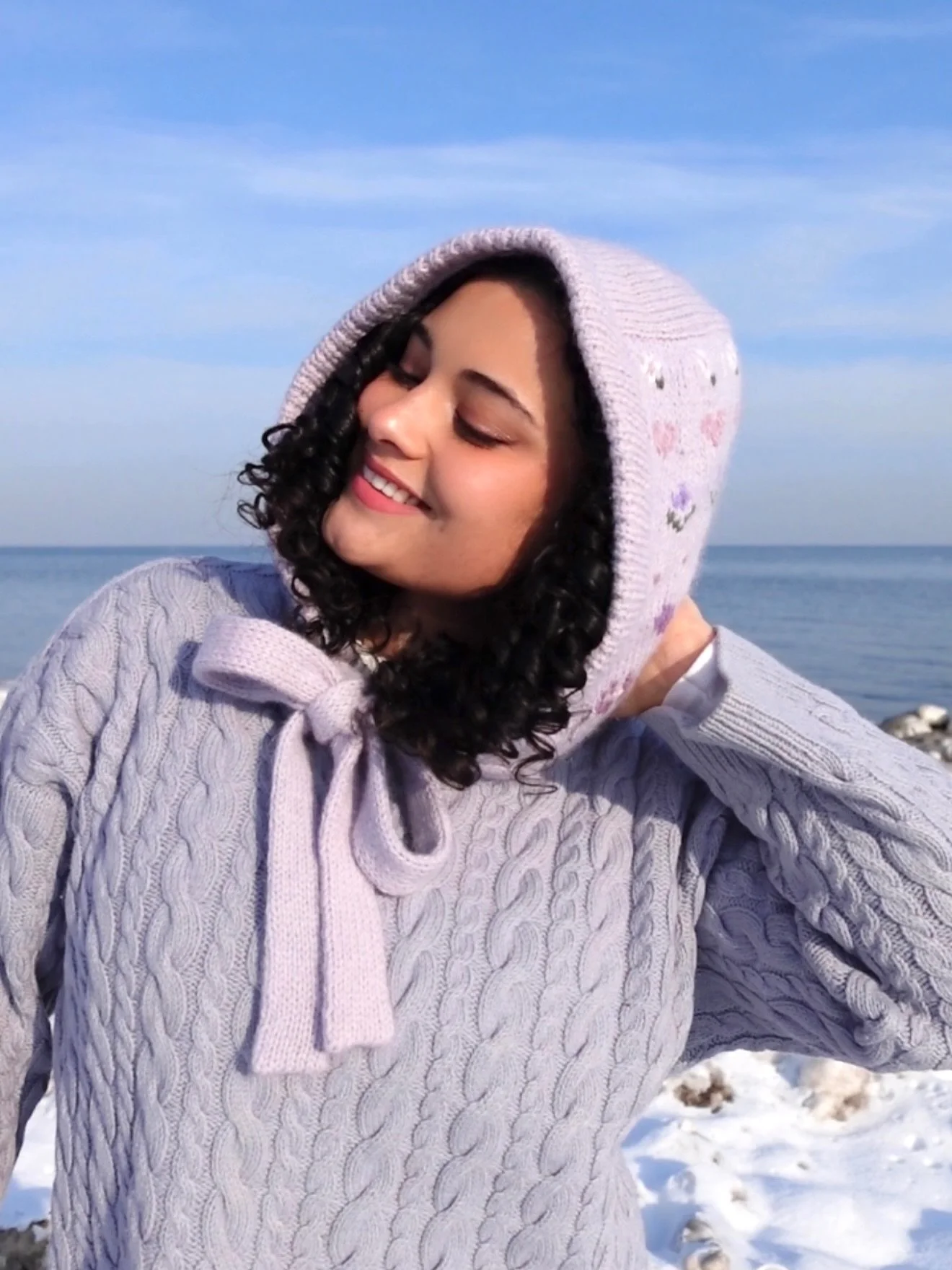 the #childhooddreamhood has been an everyday staple of mine for the past 2 years since i first cast it off 🌸🪻🌷 it is so perfect for any occasion and the motifs brighten my day up every time i see them 💜🥰 also wearing my cozy cable sweater by @an