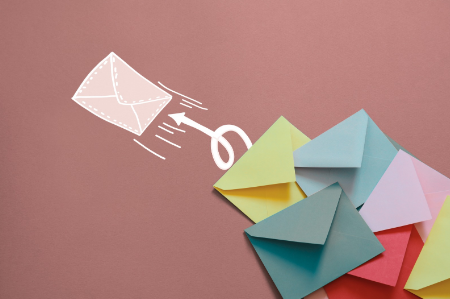 Illustration of an envelope with a line indicating it is being opened, surrounded by colorful paper envelopes on a pink background.