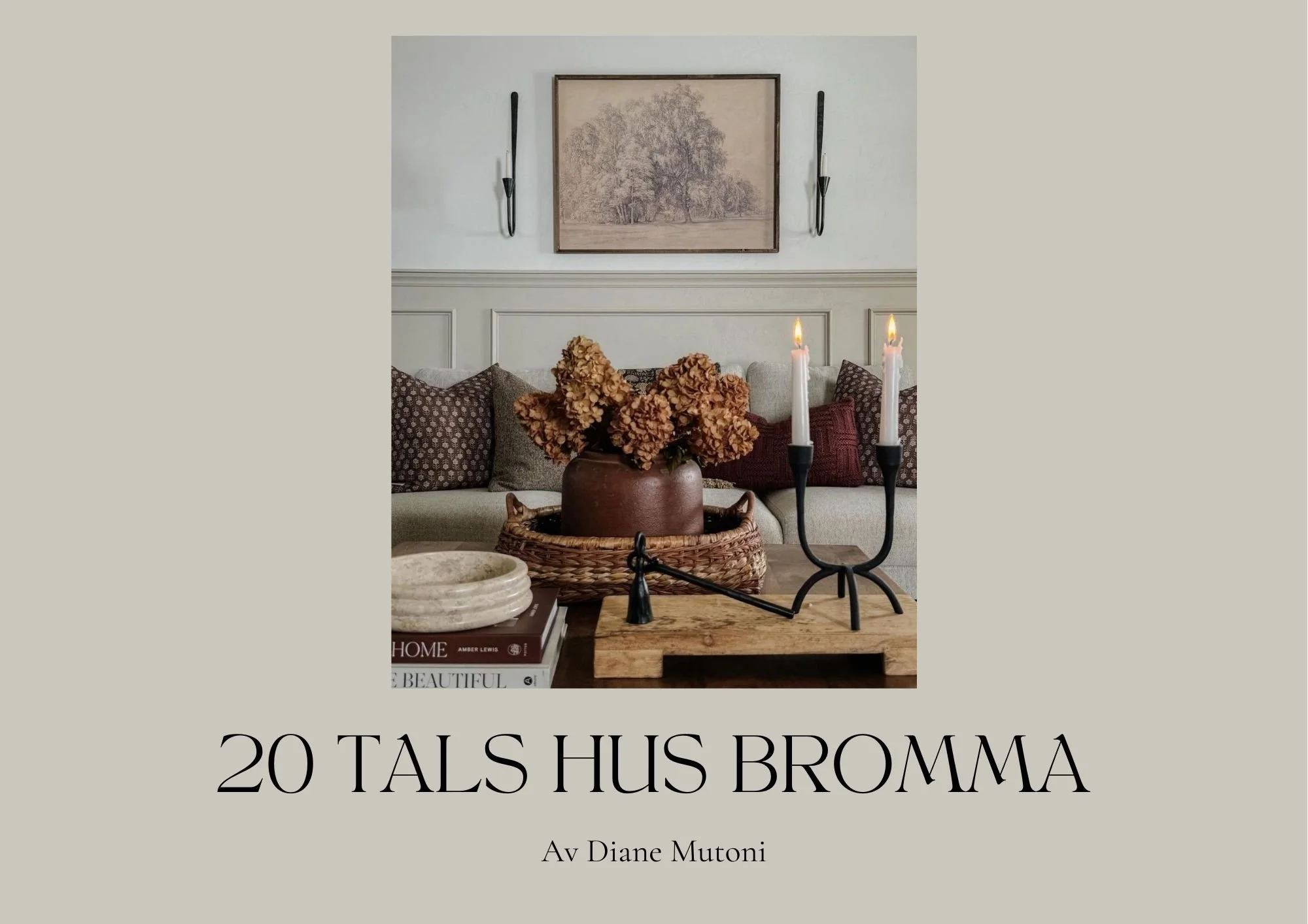 Decorative living room with a beige sofa, patterned throw pillows, framed artwork, wall-mounted candles, a table with books, a vase of dried flowers, and a candelabra with lit candles.