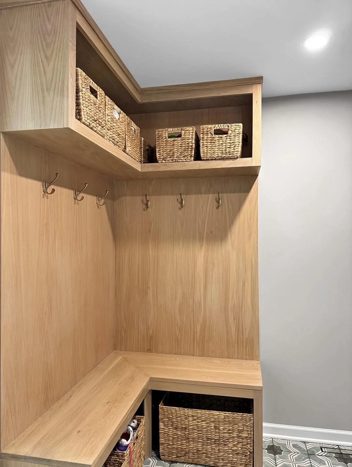 White Oak corner Built In Mudroom Hall Tree unit with baskets and coat hooks in Orchard Park, NY.  