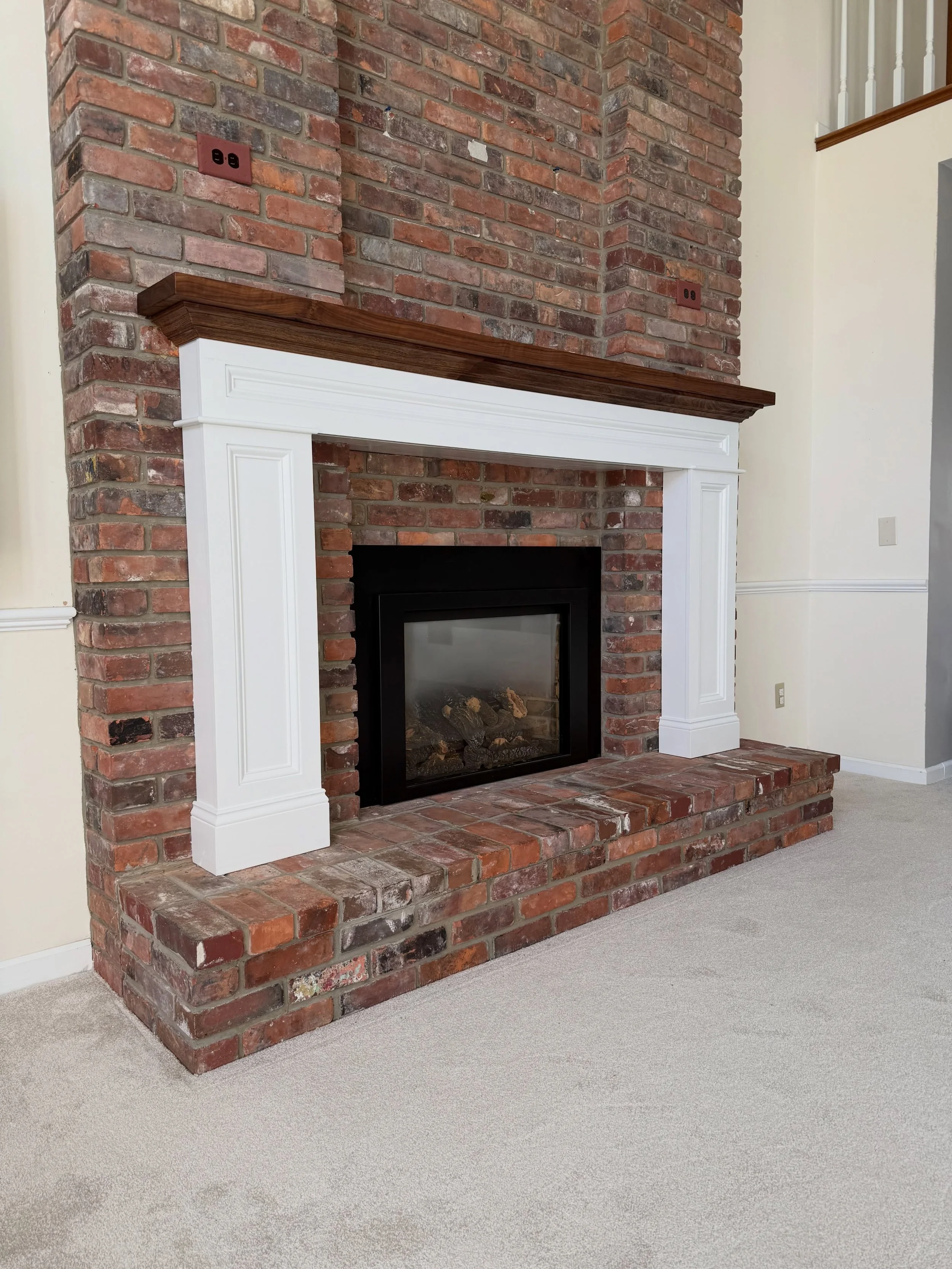 Painted white fireplace mantel with walnut top and crown molding in East Amherst, NY.