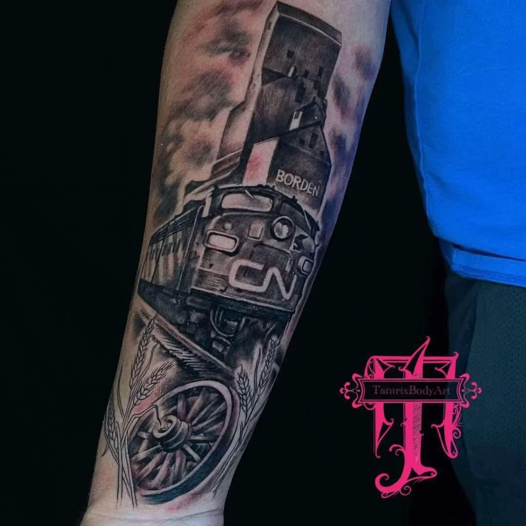 Black and gray tattoo of a train and a train station with smoke, wheat, and written 'Borden' on a person's forearm.