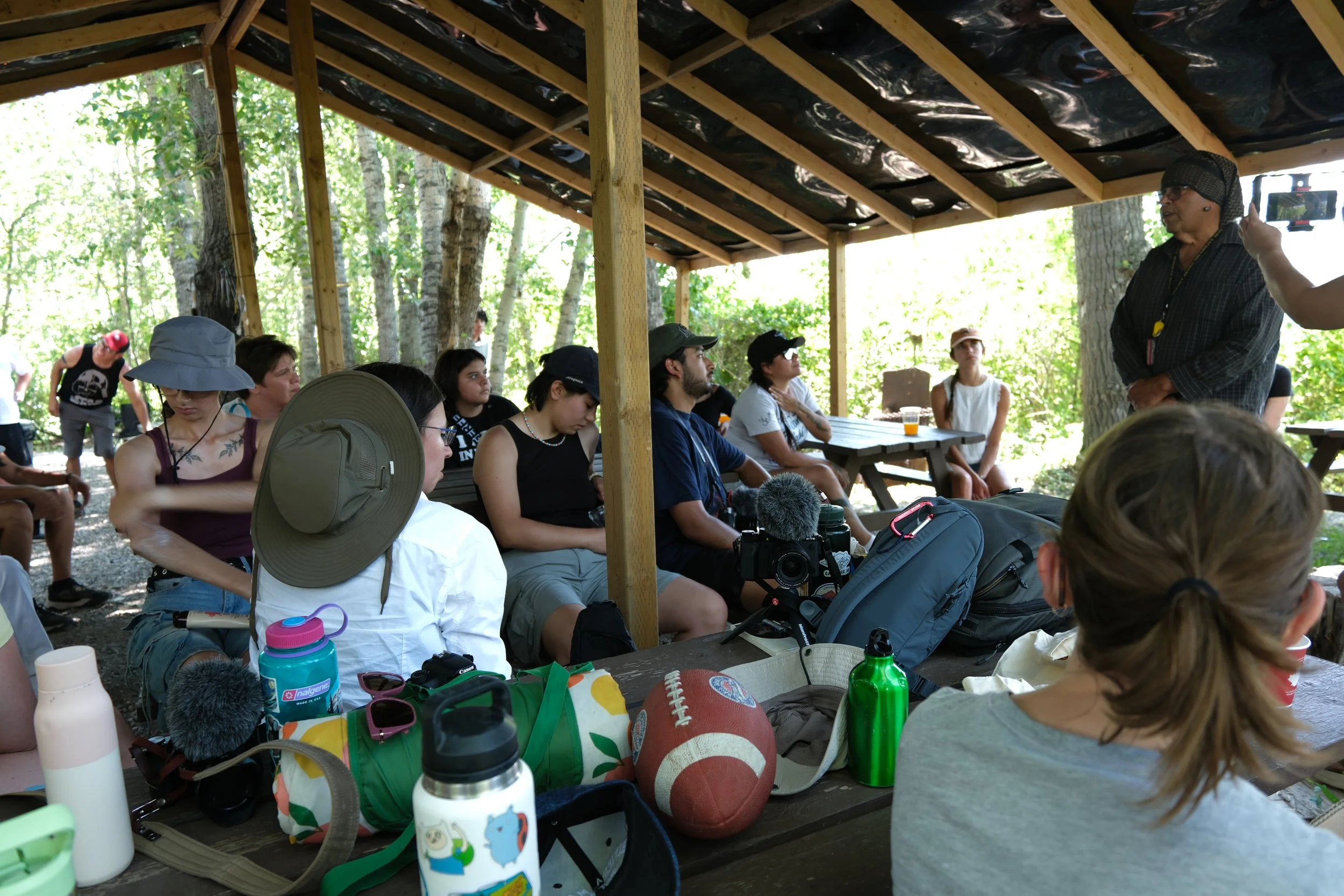 Learning from Piikani Elder Harley Bastien at Buffalo Rock Tipi Camp. Photographed by Katherine and Chloe.