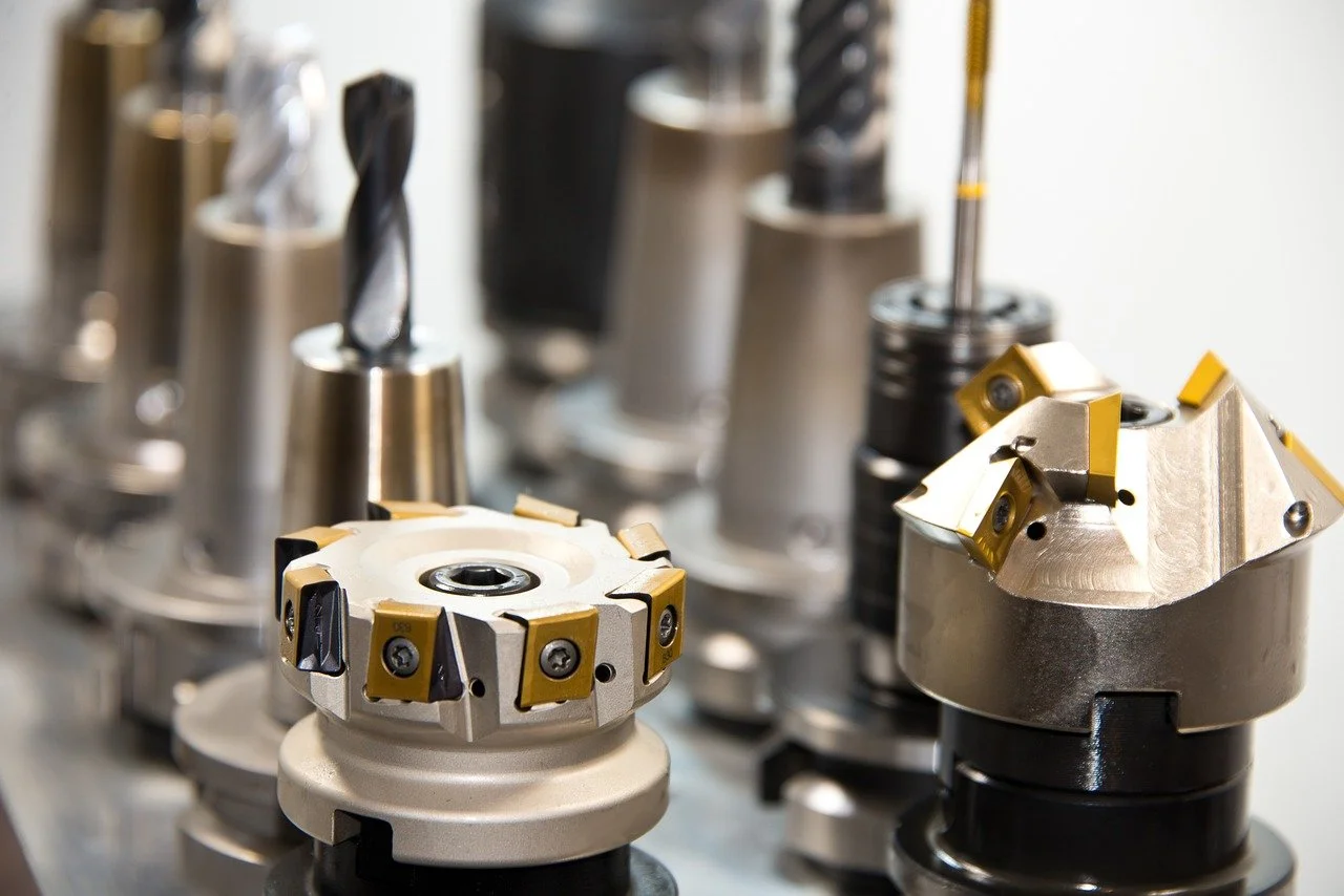 Several metal cutting tools and drill bits arranged in a close-up view.