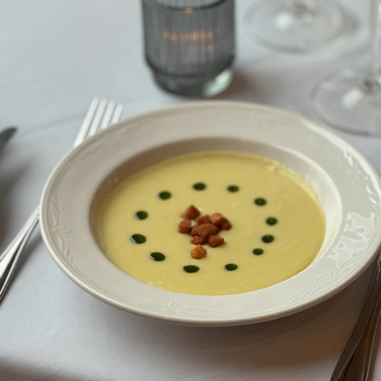 Vichyssoise soup in white bowl on table