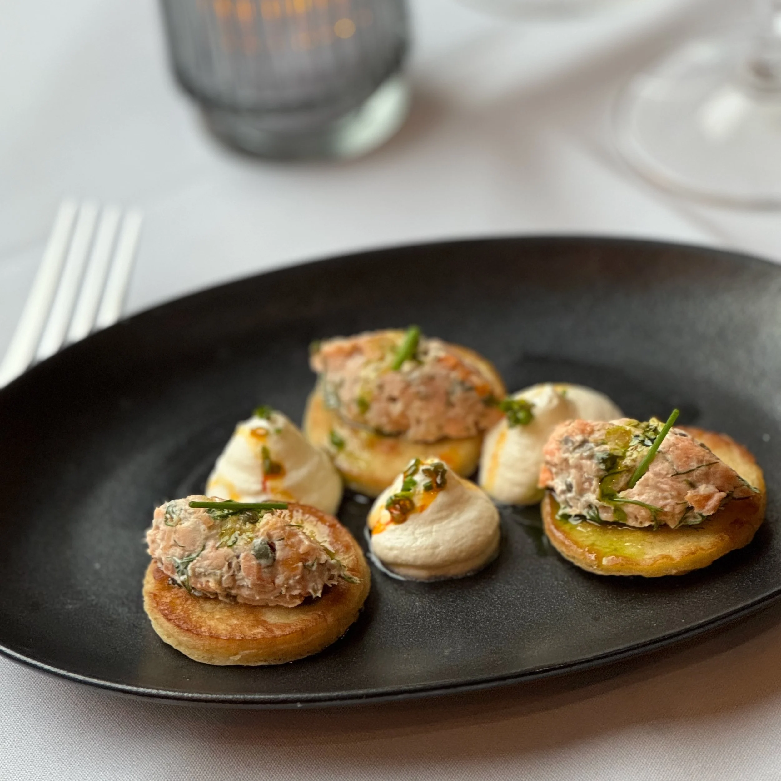 Smoked Trout Rillettes on black plate