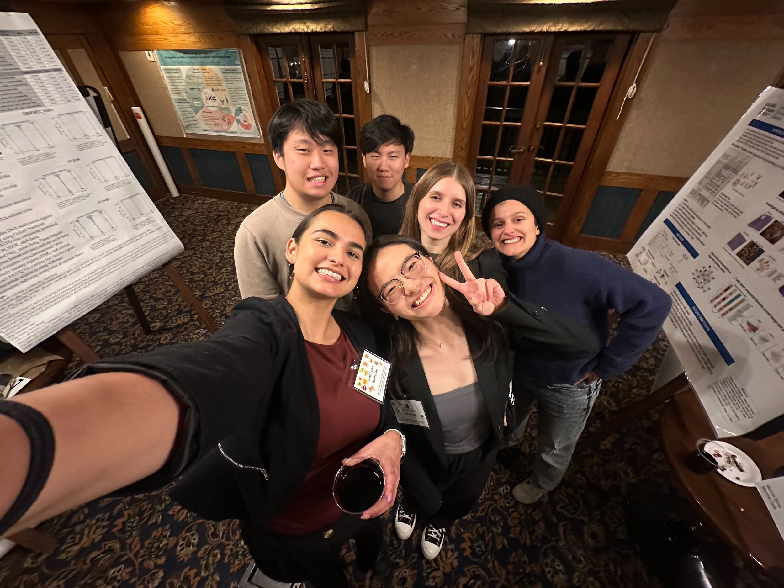 Reina Lab members in front of their LJI Retreat 2025 posters