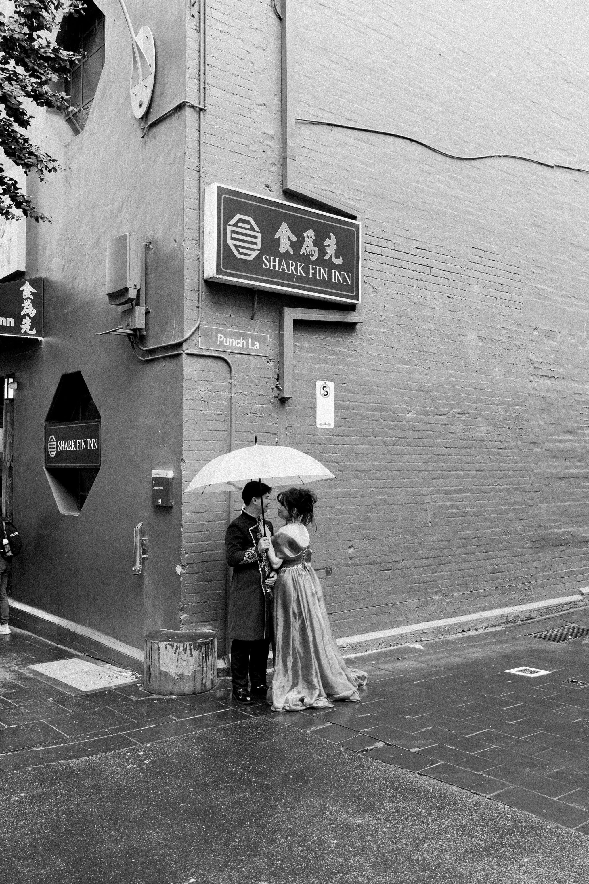Couple under an umbrella in chinatown melbourne