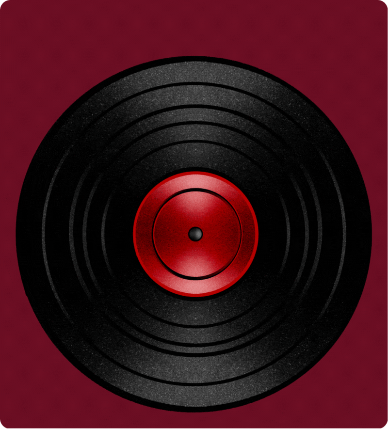 Close-up of a vinyl record with a red label, lying on a maroon surface.