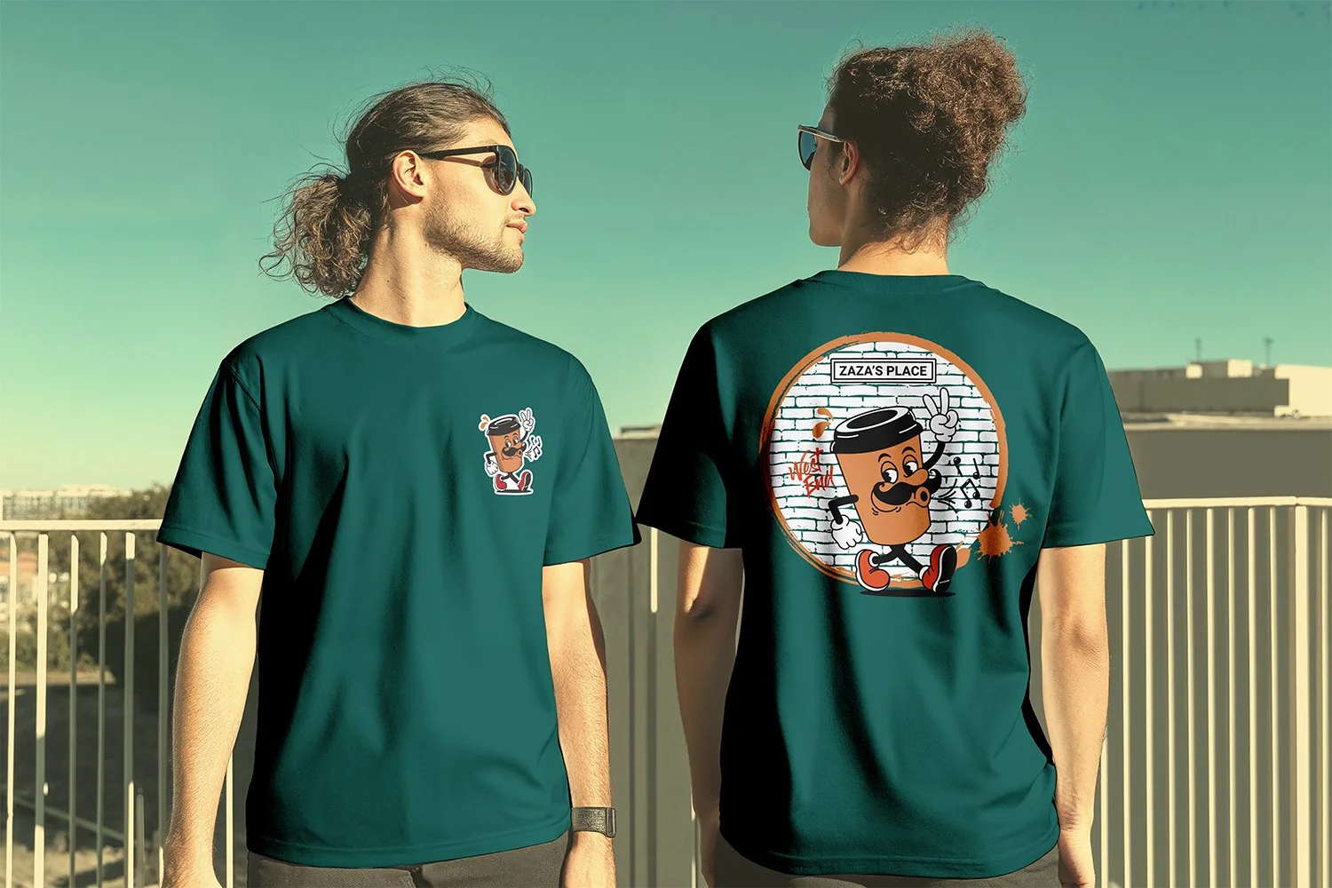 Two young men wearing green T-shirts with cartoon character designs, standing outdoors on a rooftop with a railing and buildings in the background.