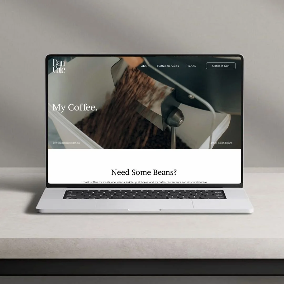 Open laptop displaying a coffee website with an image of coffee beans being roasted and text about coffee services.