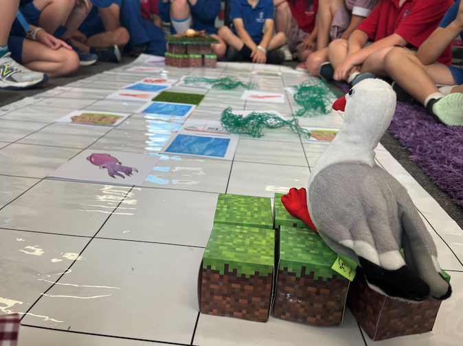 Tamariki testing an algorithm using a Blue-Bot, following a path or creating a journey to learn computational thinking foundations.