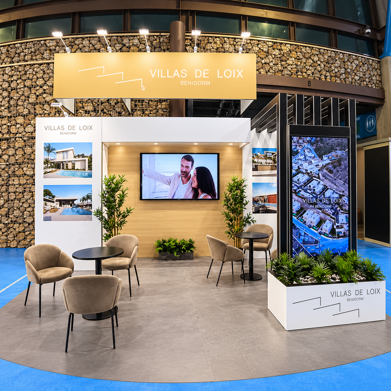 Villas de Loix exhibition stand featuring custom branded structures, integrated TV display, promotional graphics and furnished meeting area.