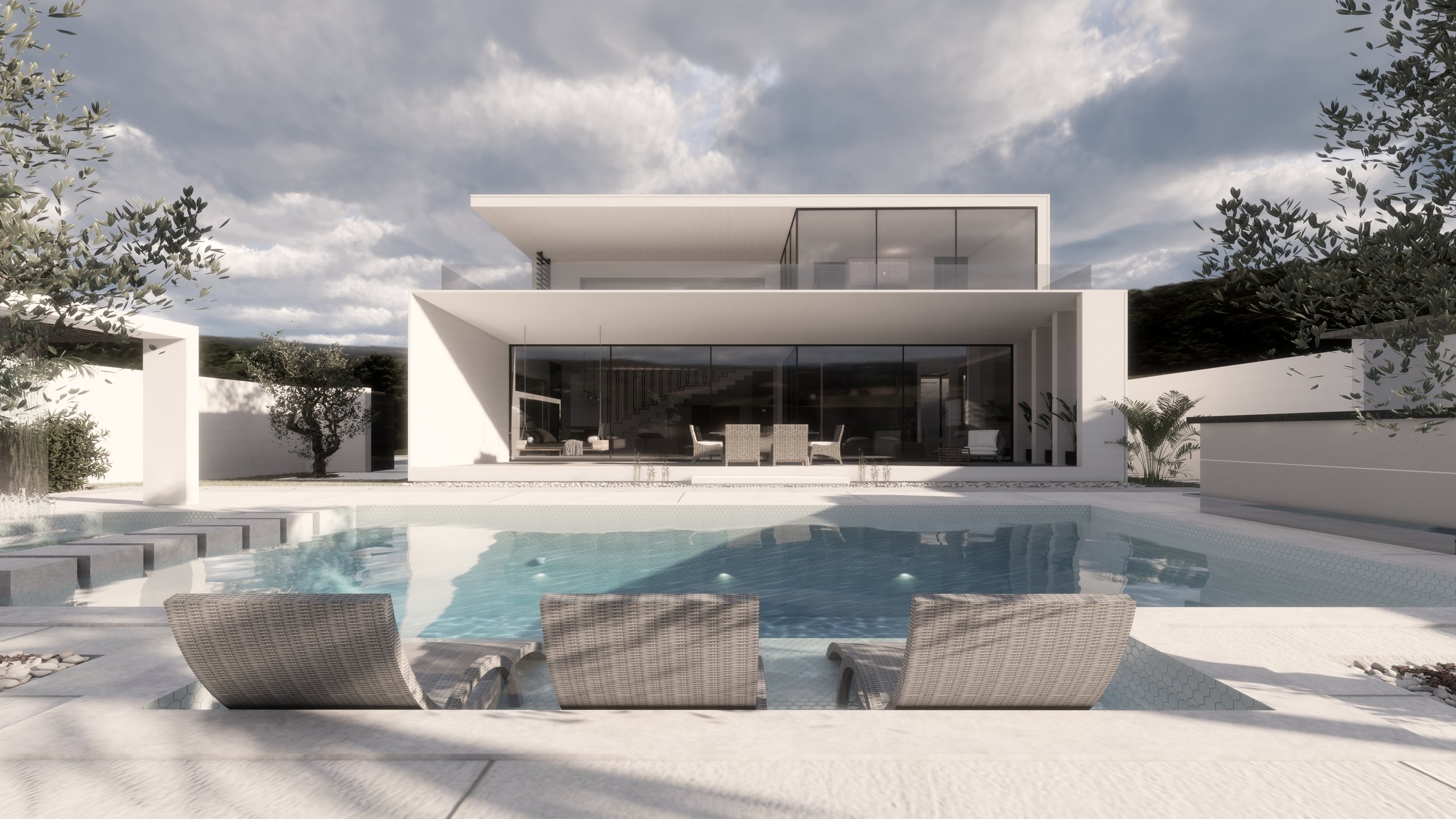 Modern white two-story house with large glass windows, outdoor patio area with dining table and chairs, swimming pool with lounge chairs, surrounded by trees and a cloudy sky.