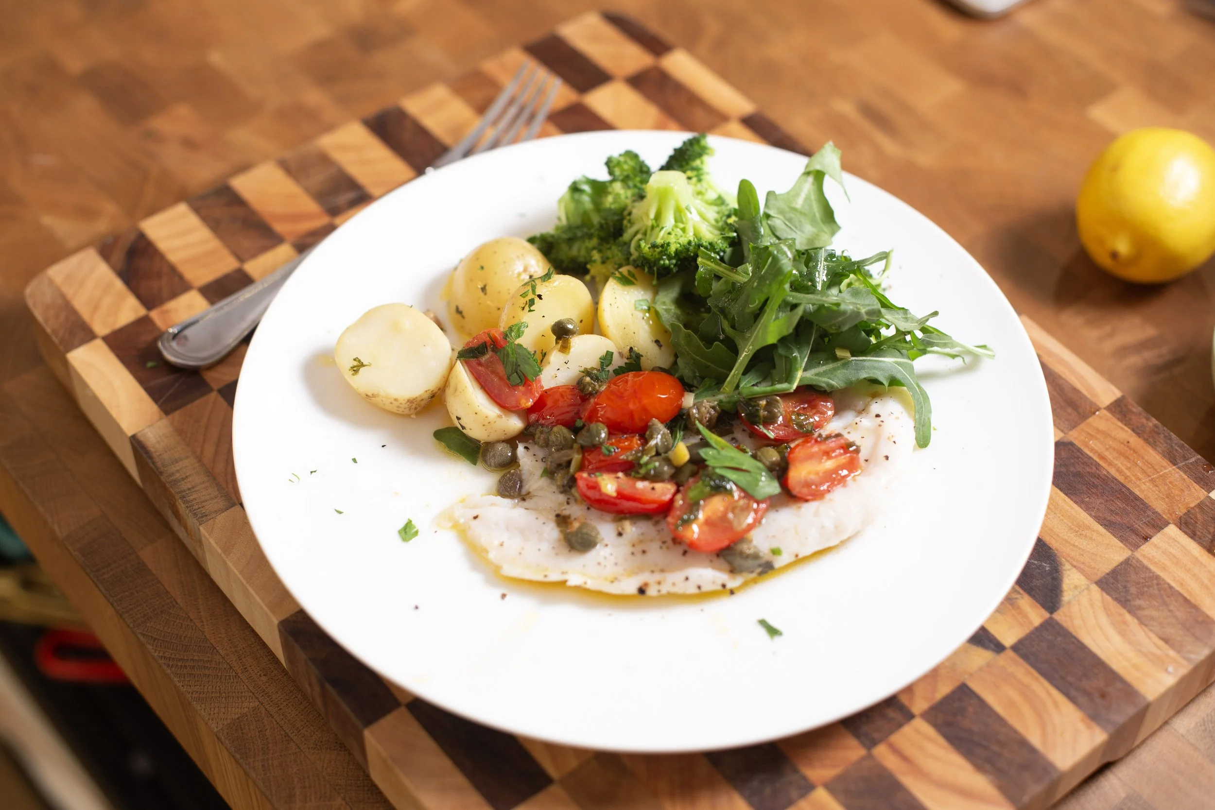 Steamed white fish with a lemon and caper butter