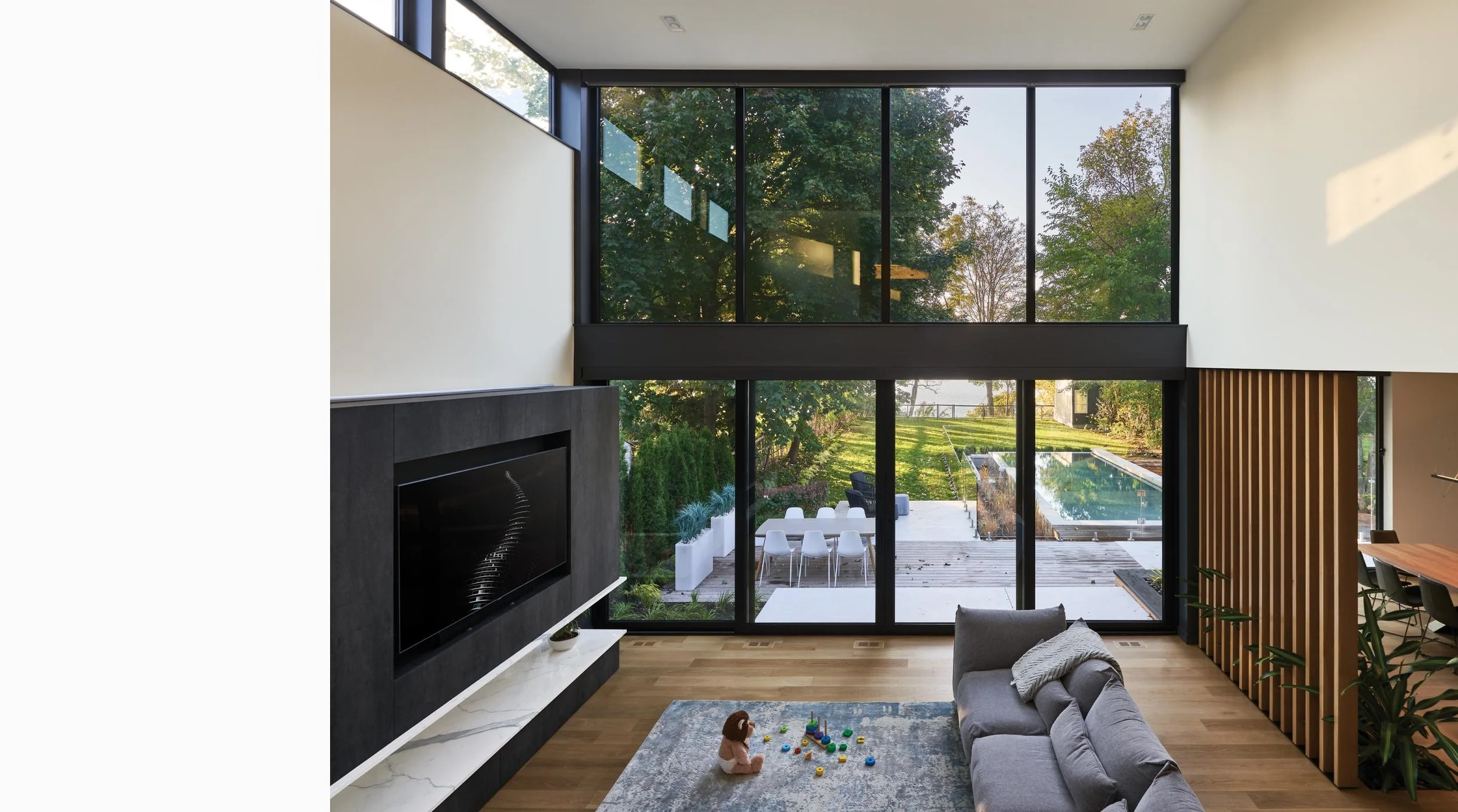 Living room looking out to patio and pool, perched on top of the Scarborough Bluffs