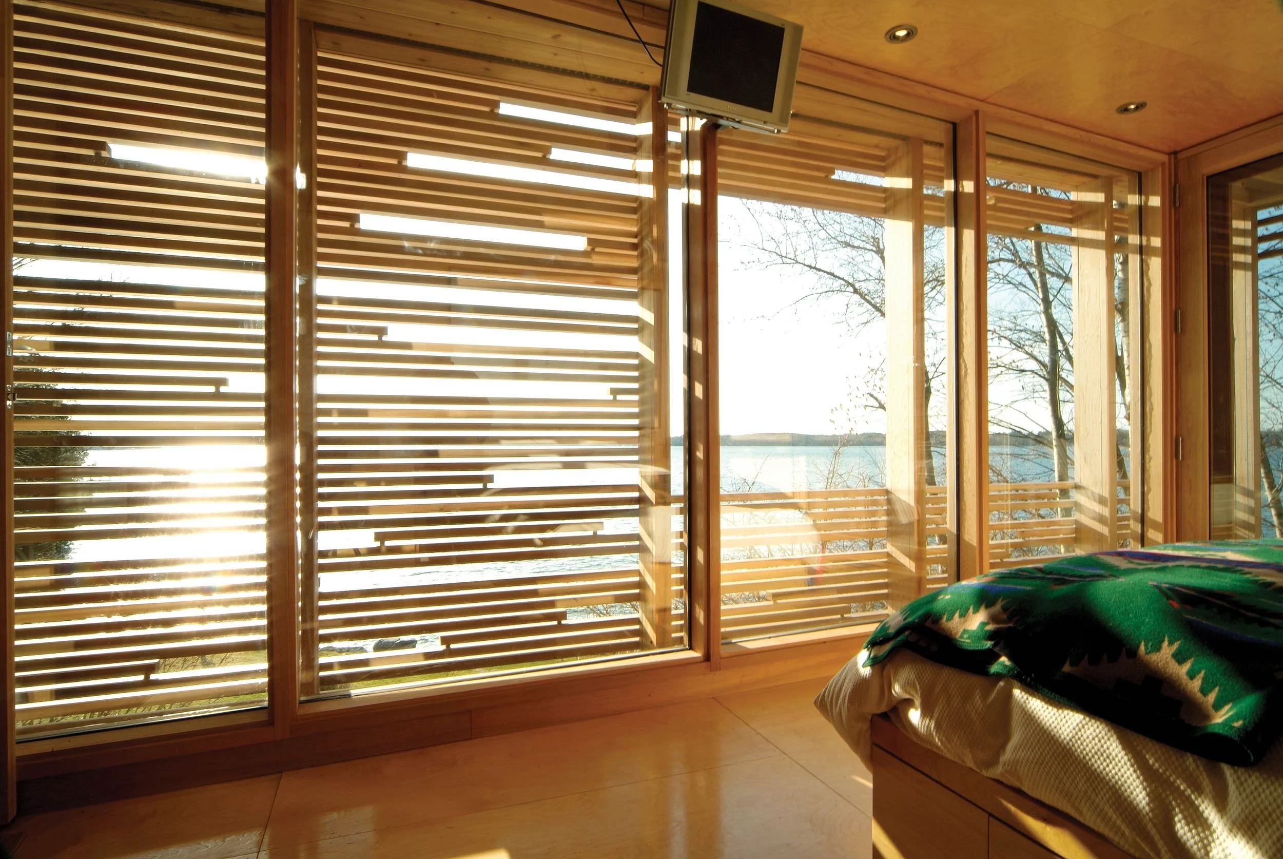 Sunset cabin interior looking out towards the patterned exterior screen