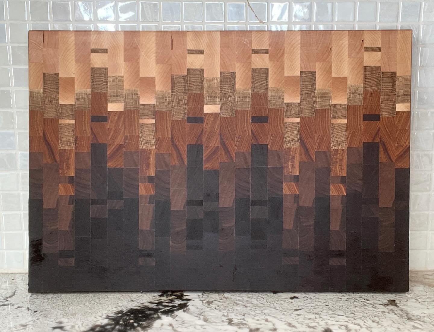This beauty consists of 5 different designs put together to create an ombr&eacute; effect.  There are 5 different types of wood used: maple, red oak, canary, walnut, Peruvian walnut and wenge.  Check out the video to see how it was made!