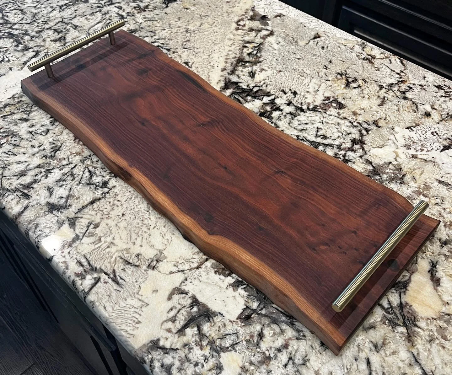 This is a live edge walnut charcuterie board and it&rsquo;s a beaut!  For those that don&rsquo;t know, a live edge refers to the natural edge of the wood.  It always adds such a fun detail to the board!