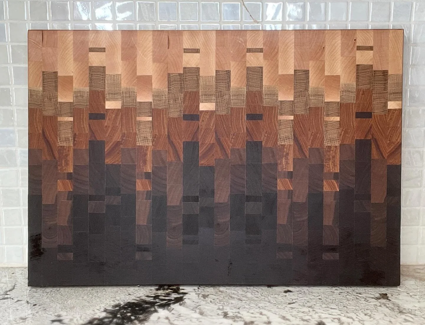 This beauty consists of 5 different designs put together to create an ombr&eacute; effect.  There are 5 different types of wood used: maple, red oak, canary, walnut, Peruvian walnut and wenge.  Check out the video to see how it was made!