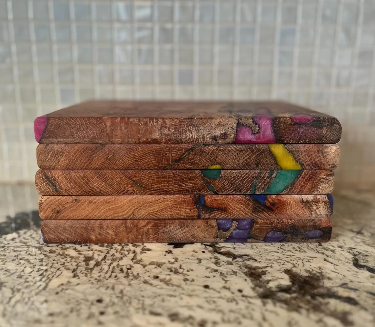 These are small cutting boards made from red oak with resin poured into the natural cracks and holes.  It was a custom order and each board has a family member&rsquo;s favorite color!