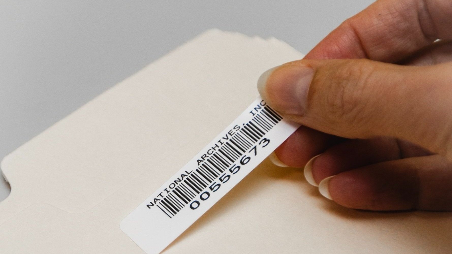 File being labeled with a barcode for secure tracking and records management