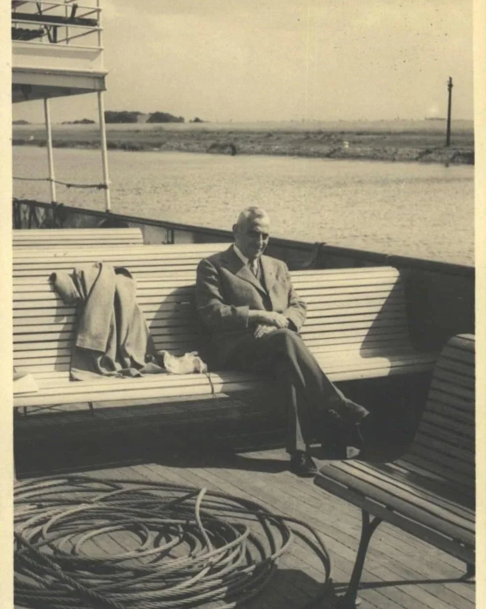 Digitized historic photograph showing Wilhelm Kleemann sitting on a bench in the early 1900s, preserved through archival scanning.
