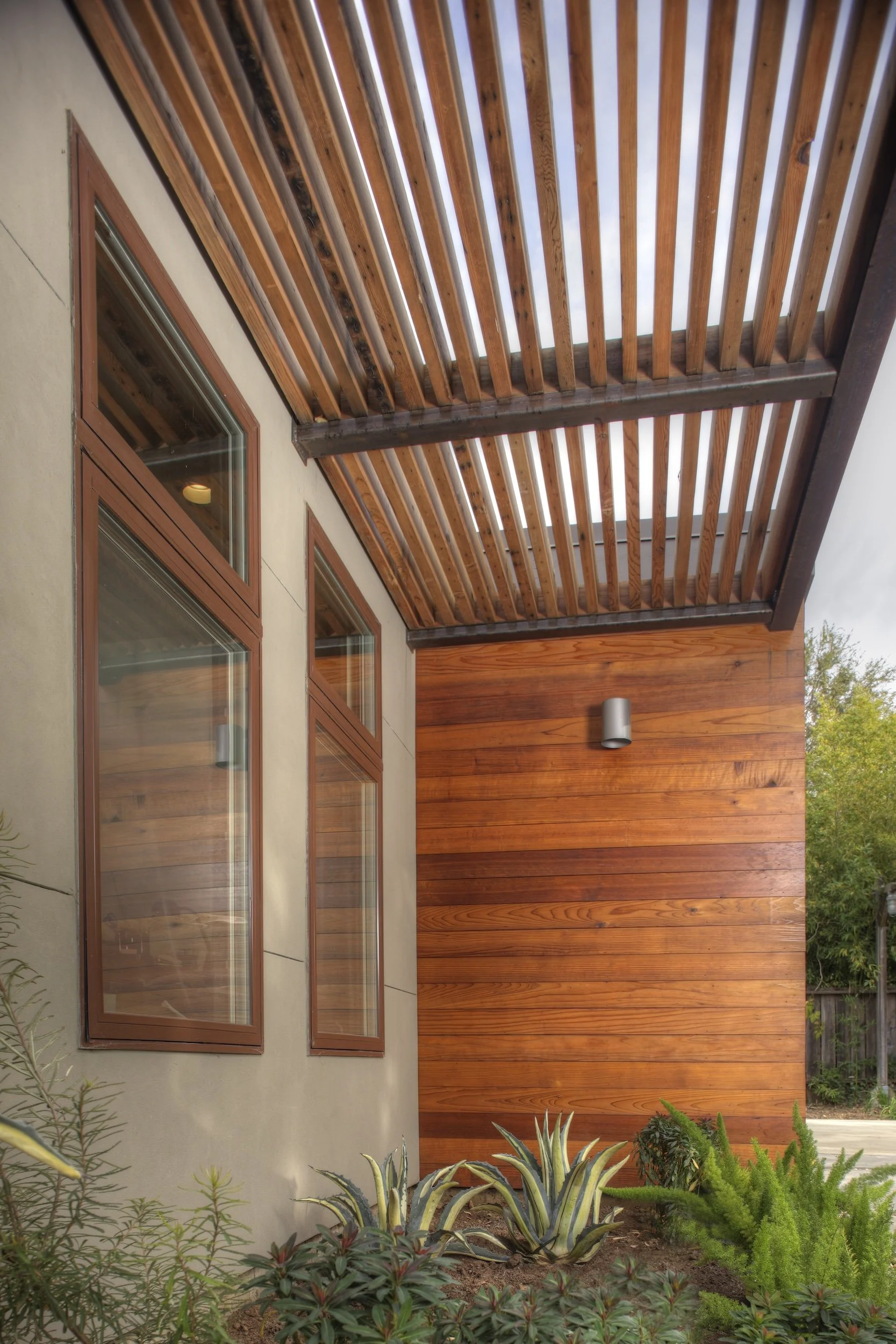 WARM WOOD ACCENTS AND PERGOLA ON EXTERIOR.jpg