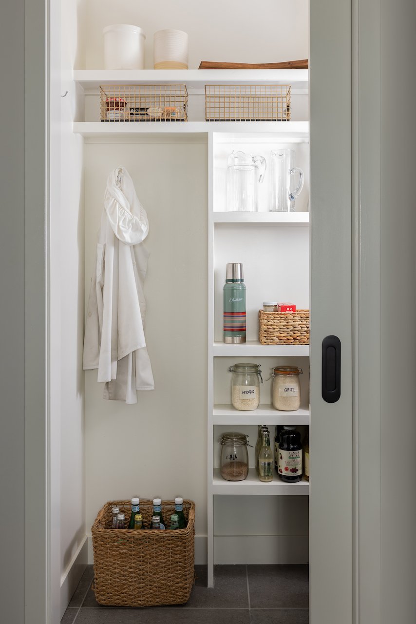 Walk-In Pantry with Built-In Shelves Behind Pocket Door.jpeg