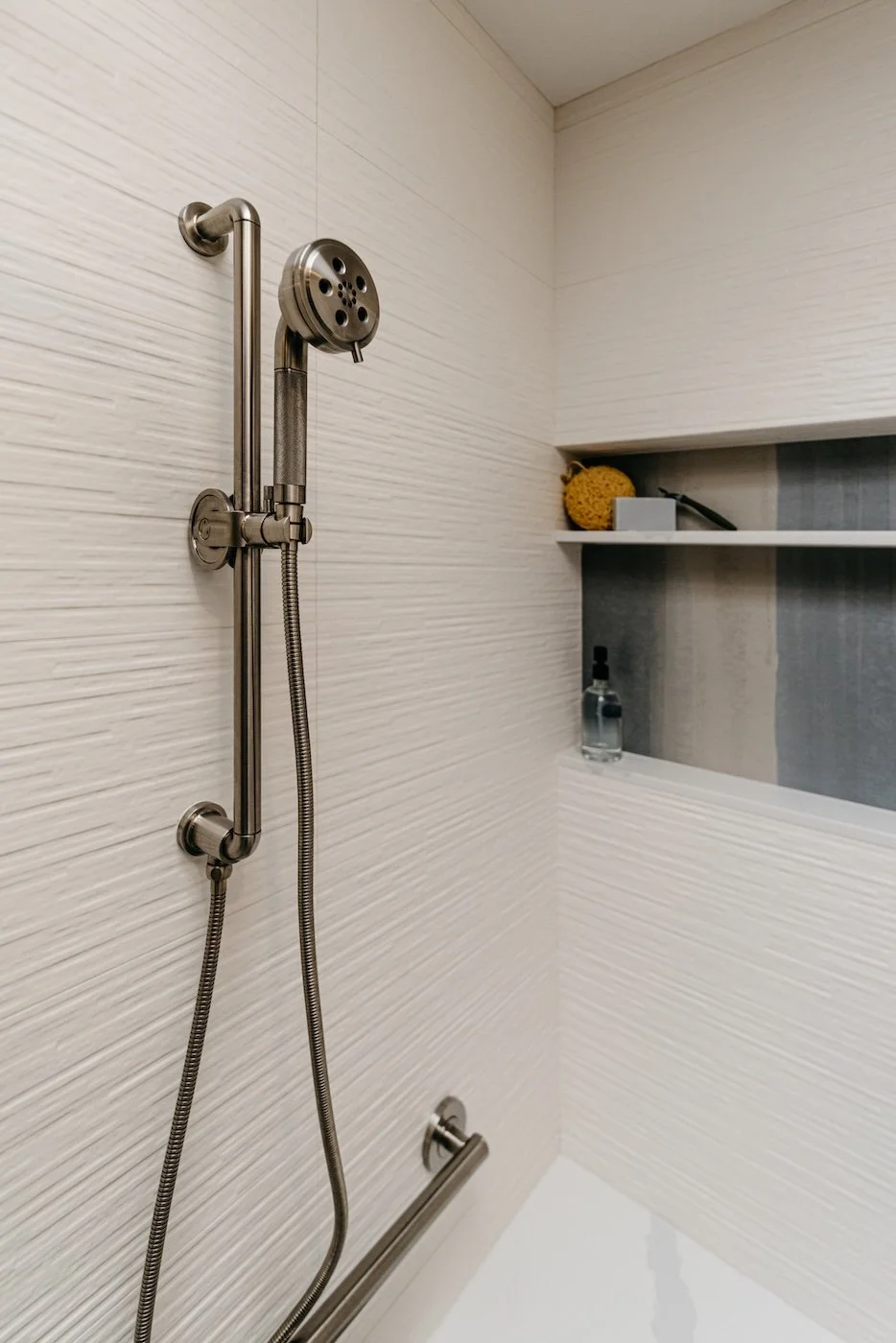 Walk In Shower with Textered Wall Tile and Accent Niche.jpeg