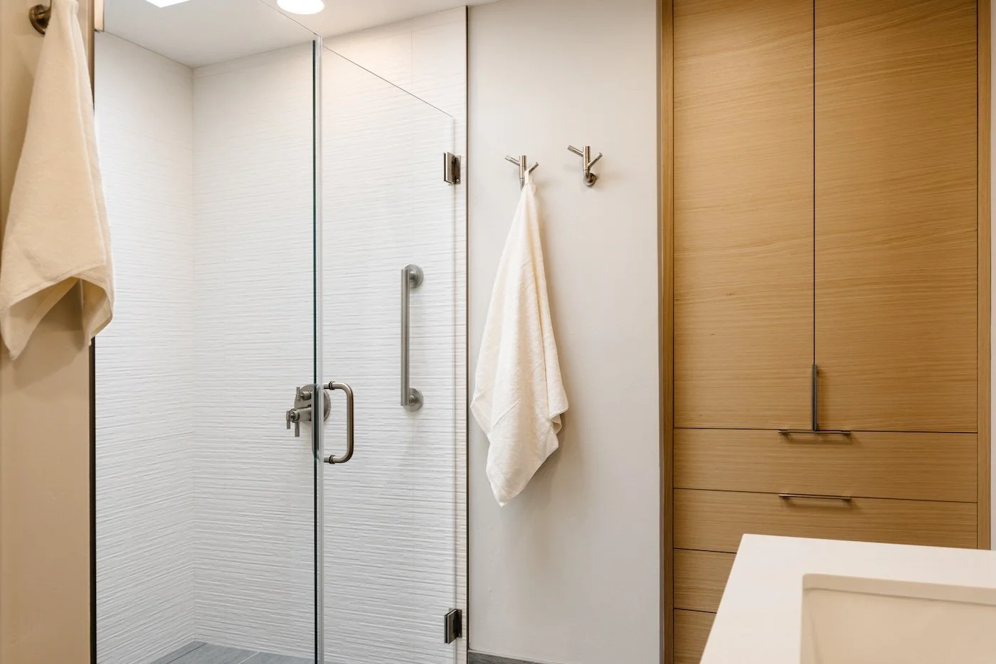 White Walk-In Shower with Rift-Cut White Oak Cabinetry.jpg
