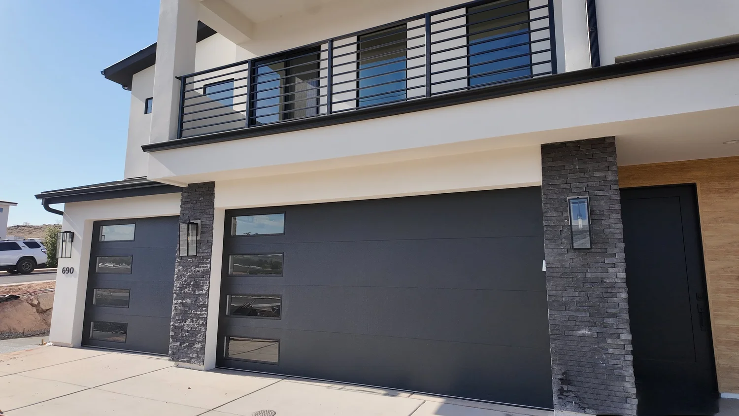 Modern Southern Utah home with dark garage doors serviced by Advanced Garage Door Works