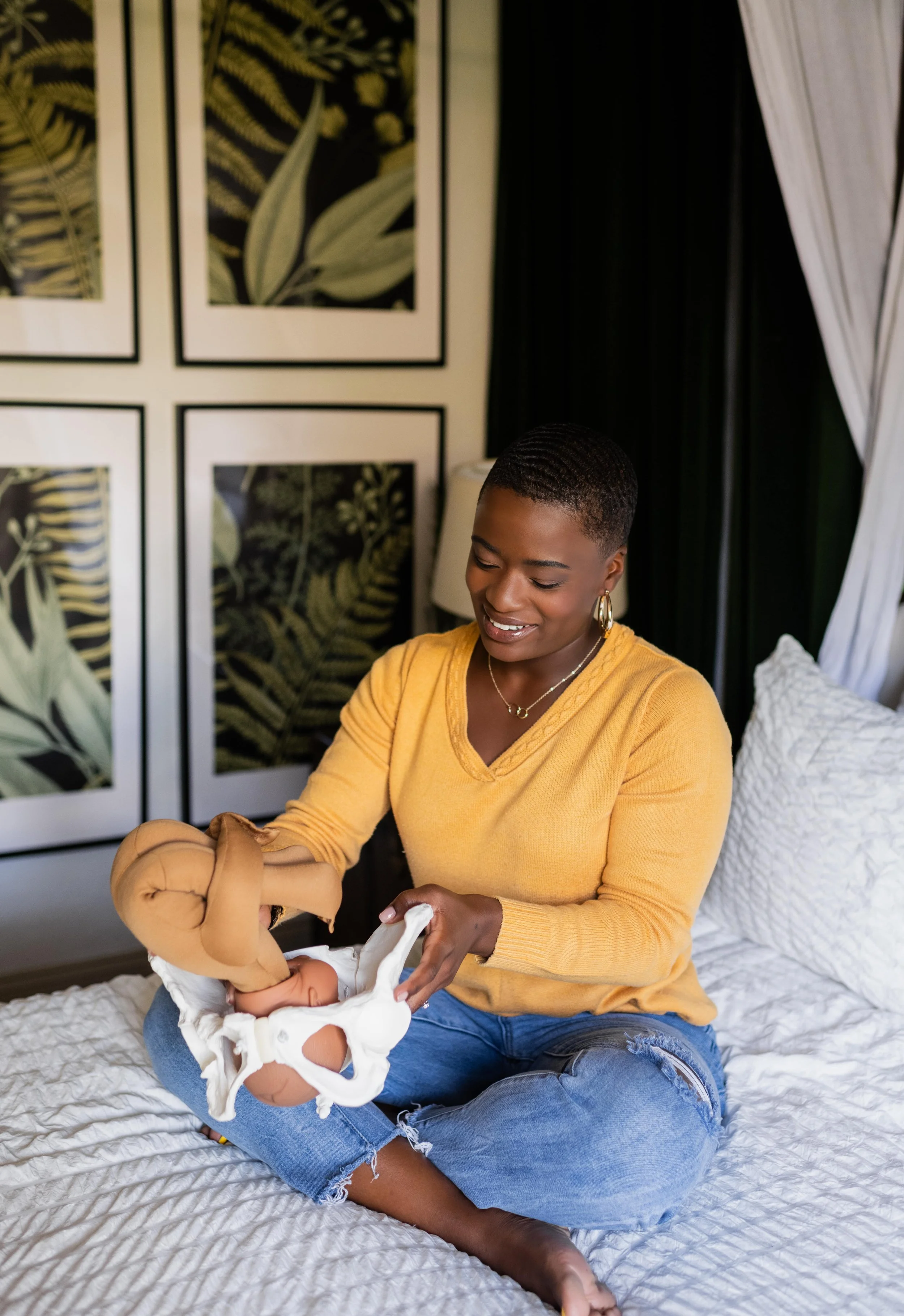 Doula Dee Larkin with baby model and pelvis model at home in Valrico, Florida.