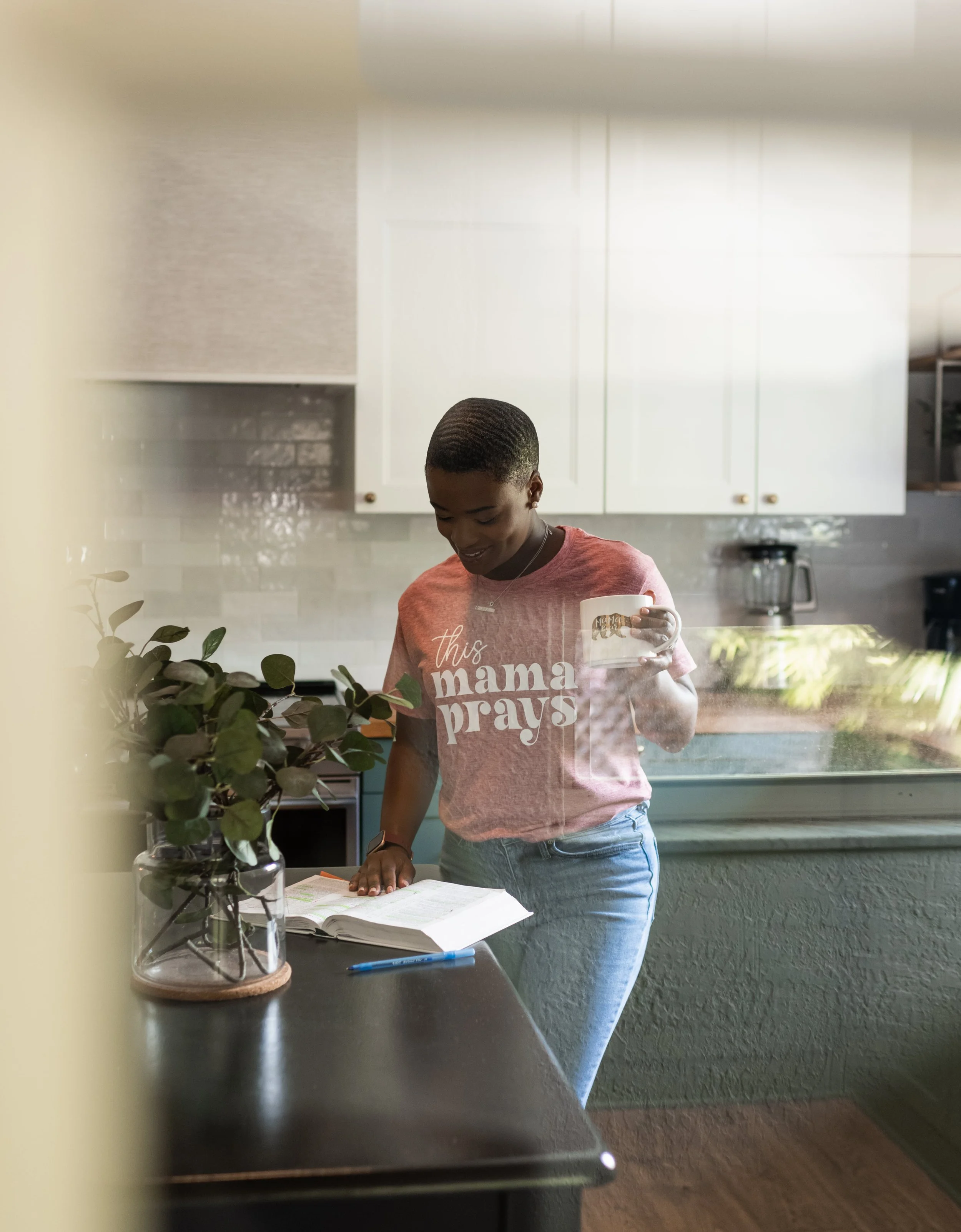 Christian all-inclusive doula Dee Larkin in kitchen with mug and bible in Hillsborough County, Florida.