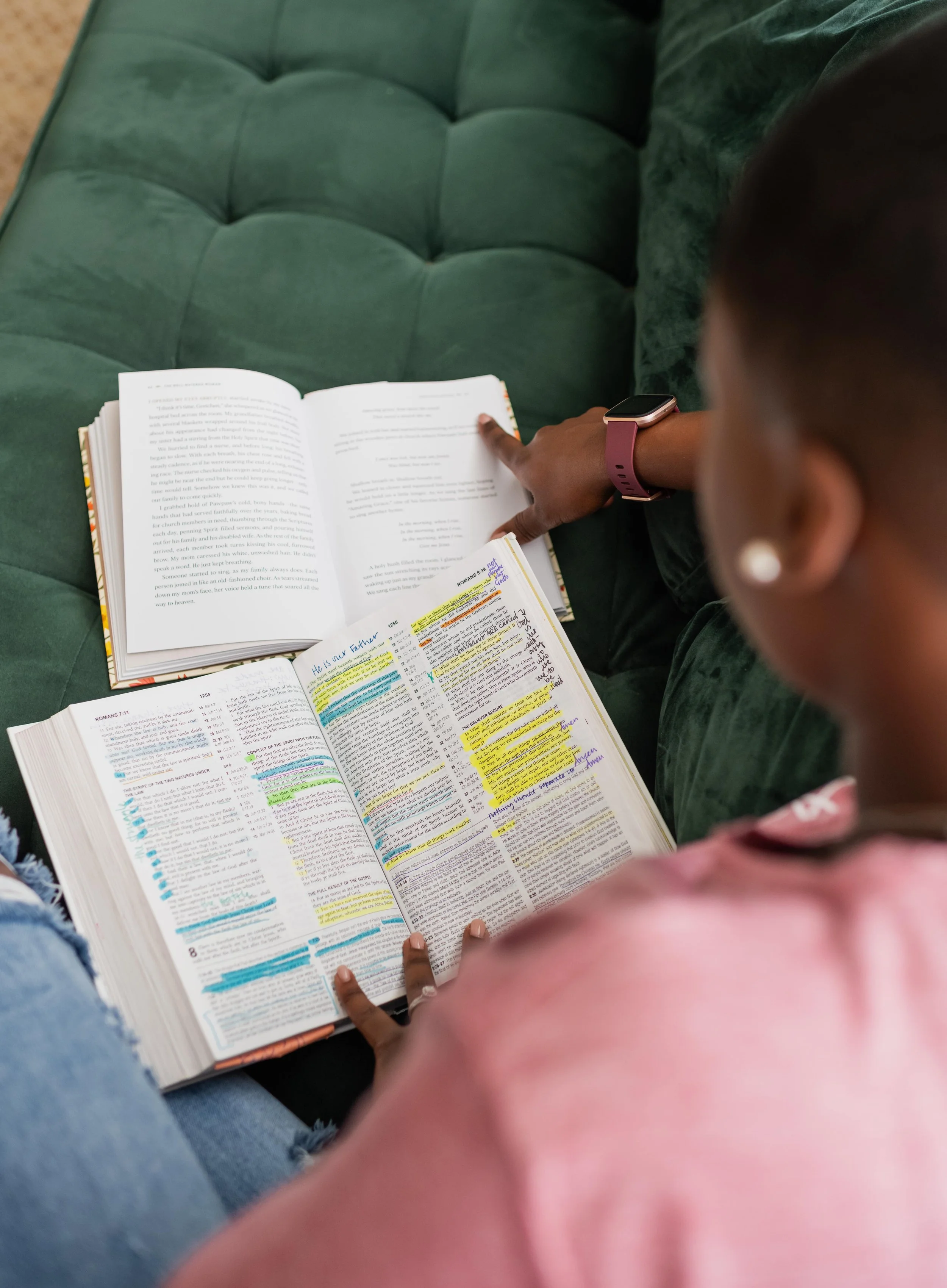 Bereavement doula Dee Larkin reading bible on couch in Tampa, Florida.