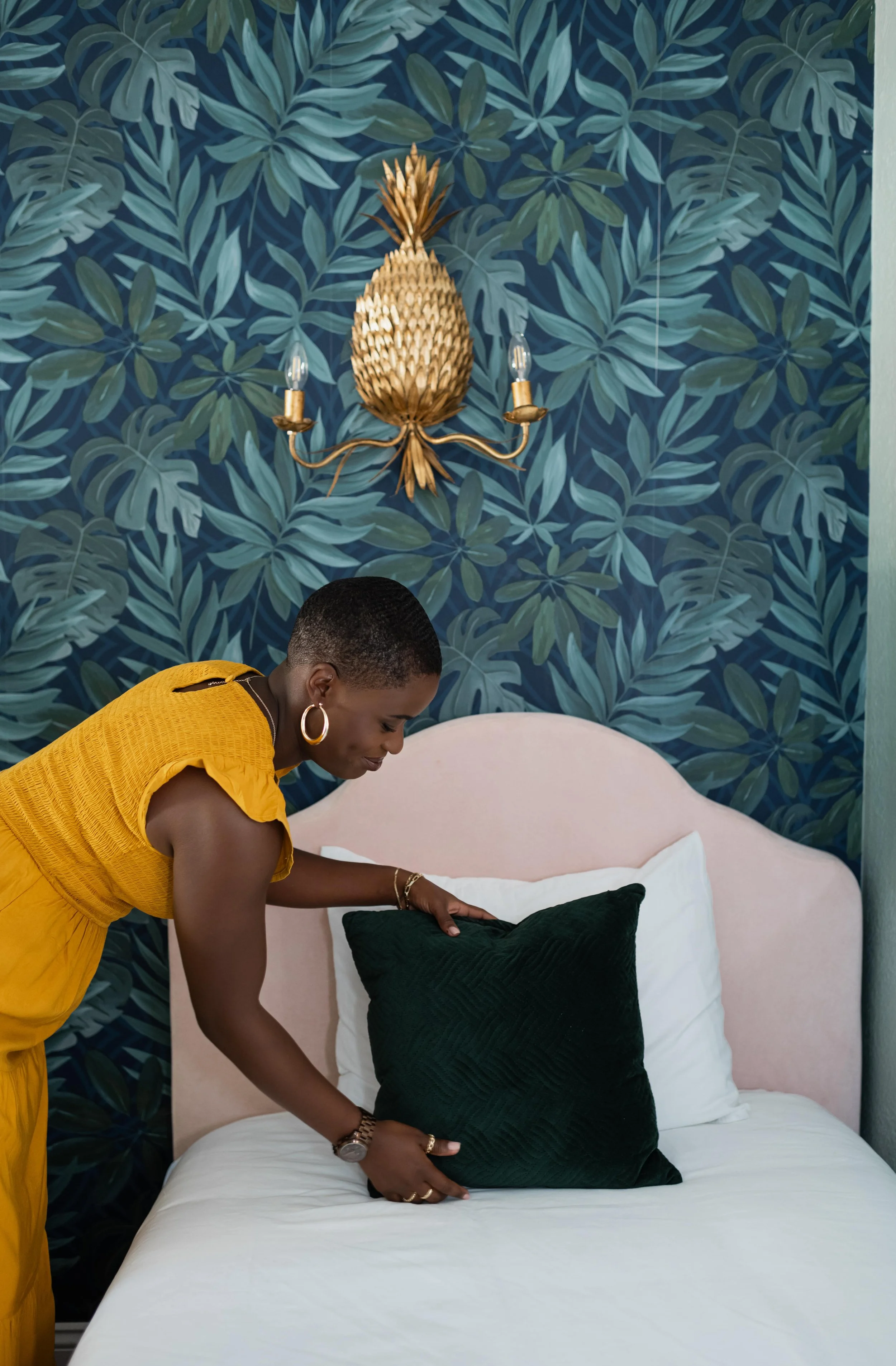 Bereavement doula Dee Larkin making bed in FishHawk, Florida home.