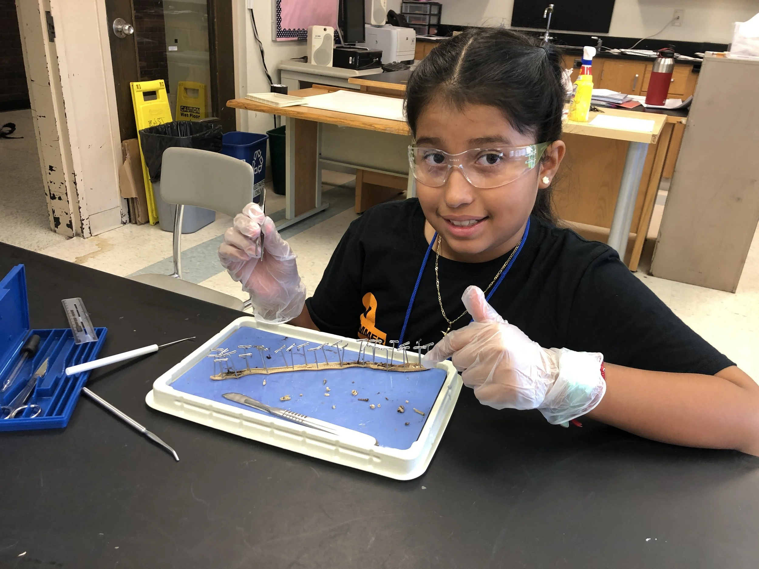 Girl in lab goggles doing a STEM activity