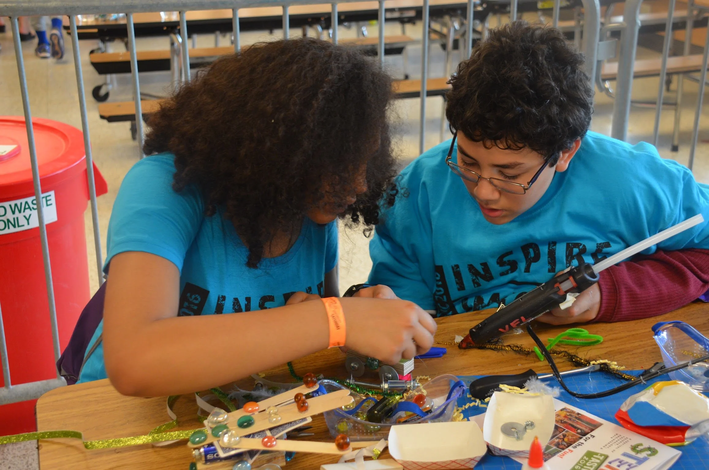 High school students working on a circuit board