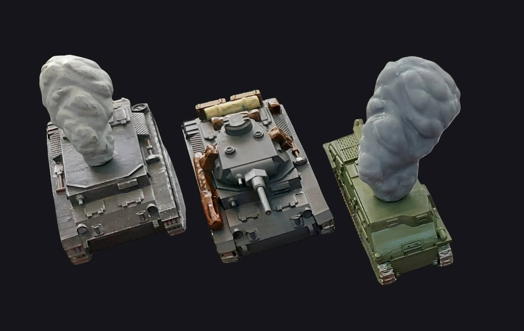 Model tanks with different turret designs and camouflage paint schemes.