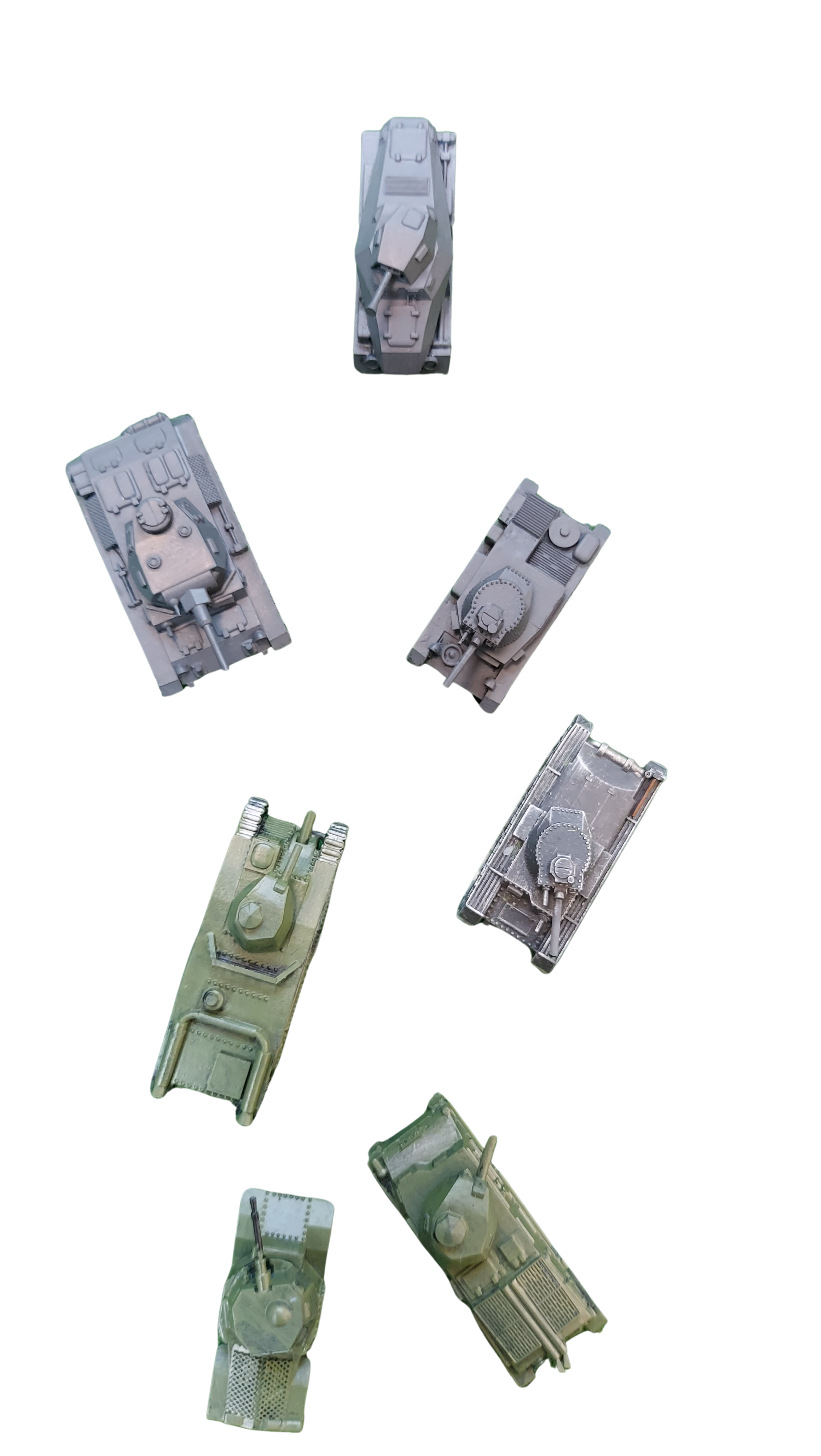 A collection of seven model tanks in various shades of grey and green, arranged in a scattered pattern on a black background.