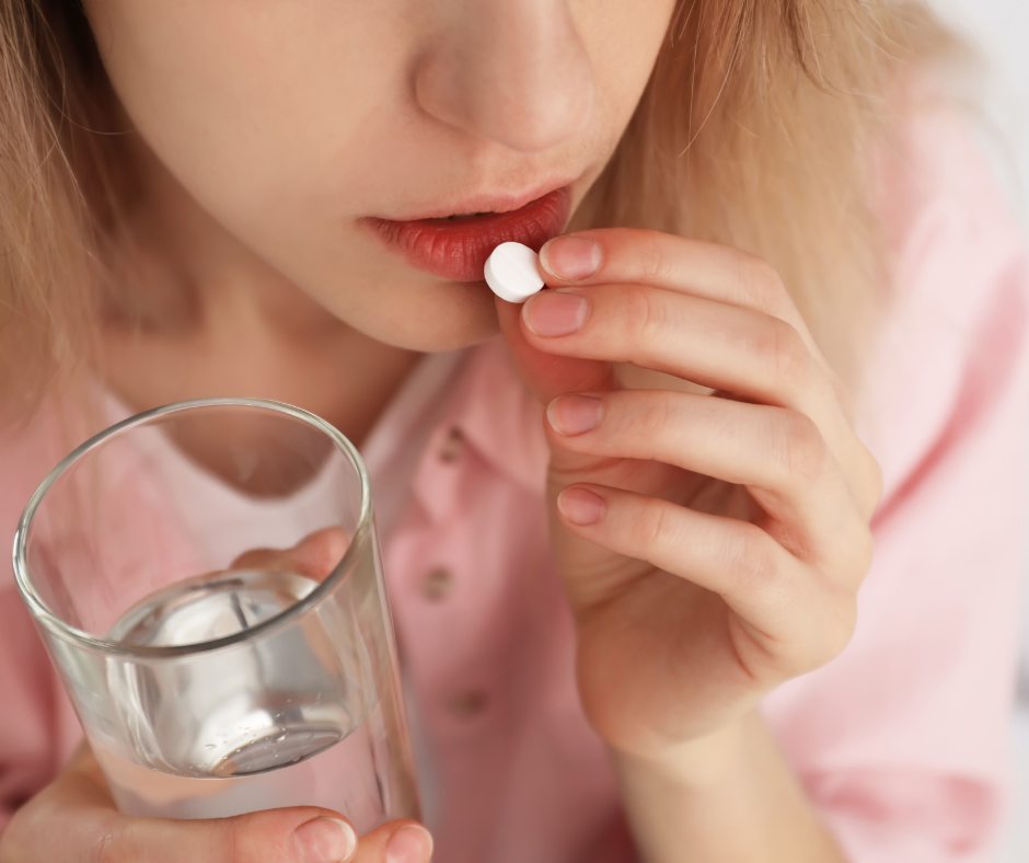 woman taking pill