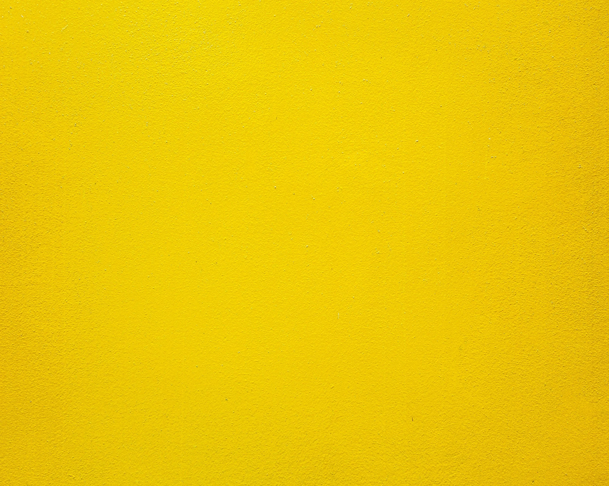 Solid yellow textured wall.