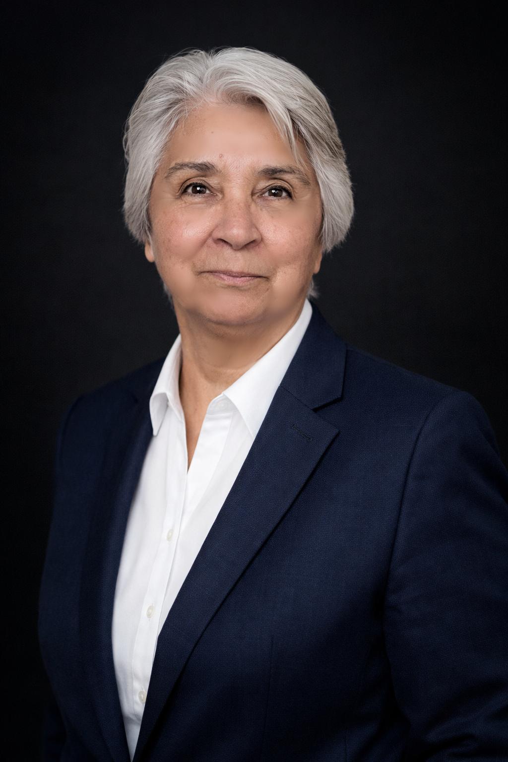 Dorothy Keon, co-chair of the board, is a senior woman with short gray hair wearing a blue t-shirt standing indoors.